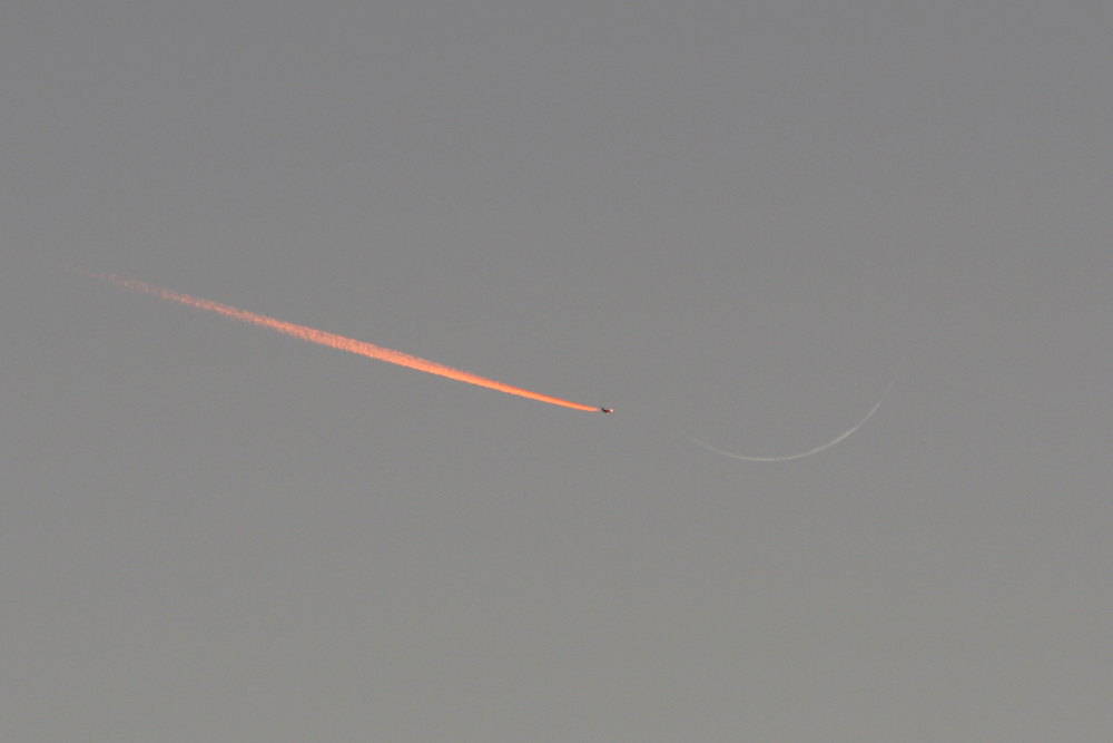 Jet Approaching a Crescent Moon