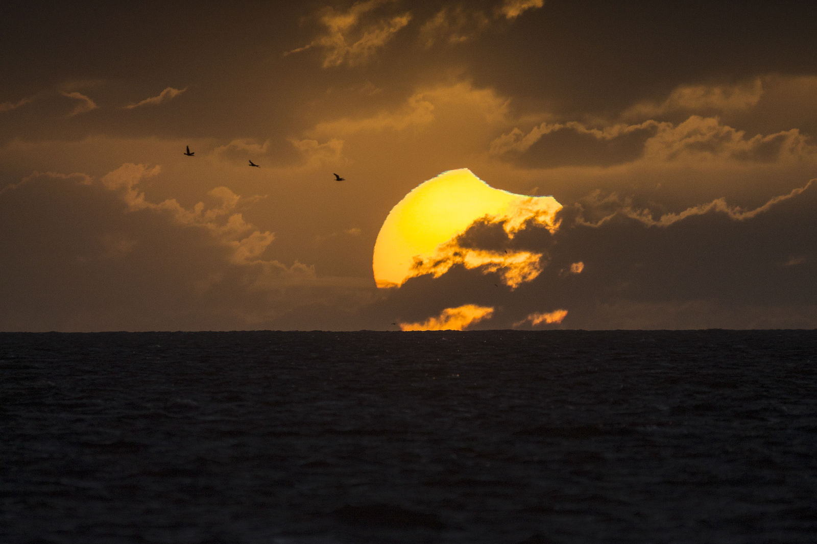 A Partially Eclipsed Setting Sun