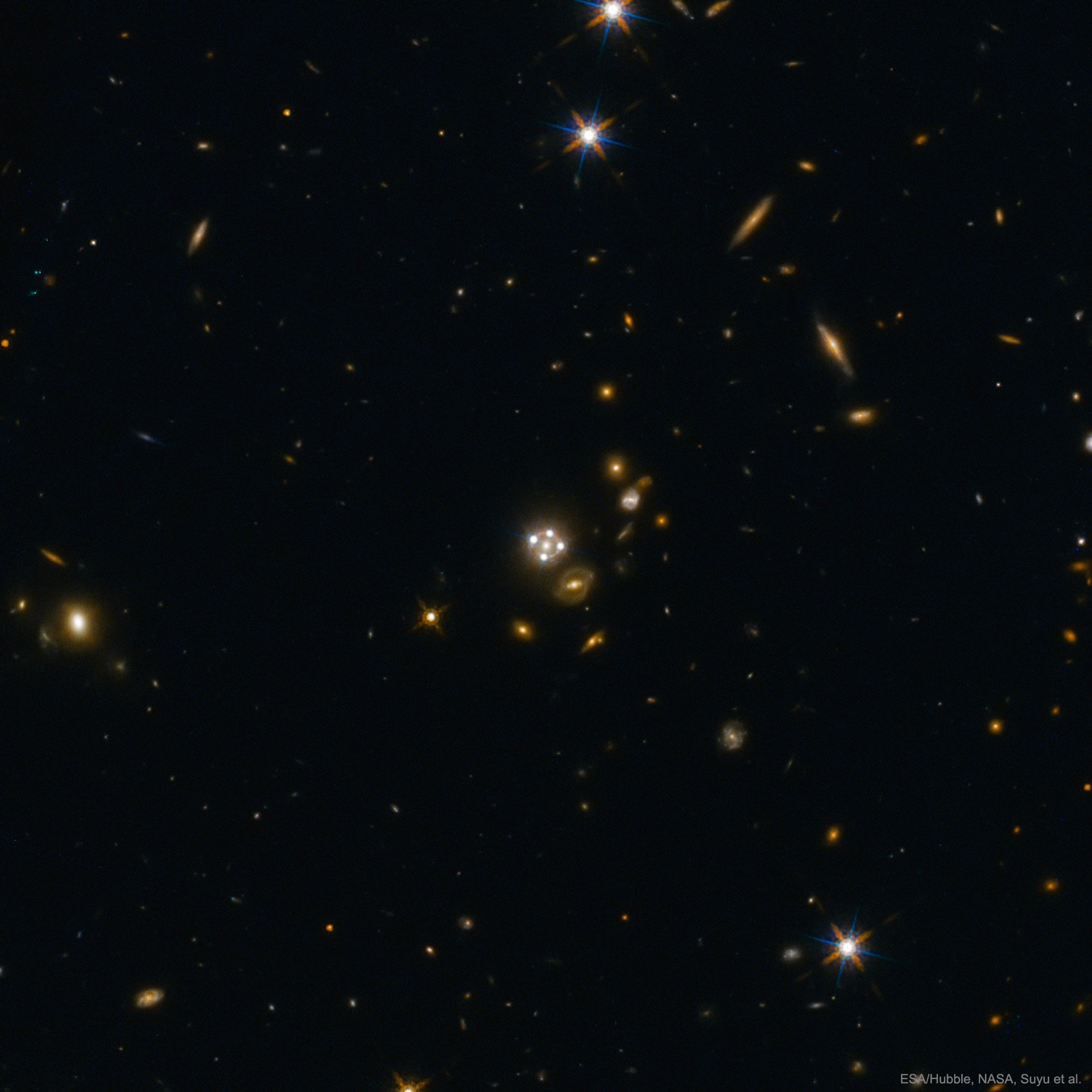 Four Quasar Images Surround a Galaxy Lens