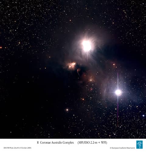 Dust and Gas Surrounding Star R Coronae Australis