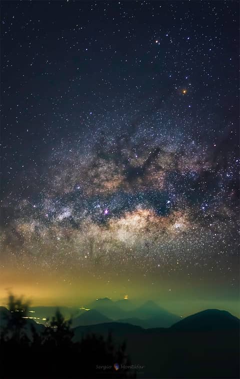 Milky Way over Erupting Volcano