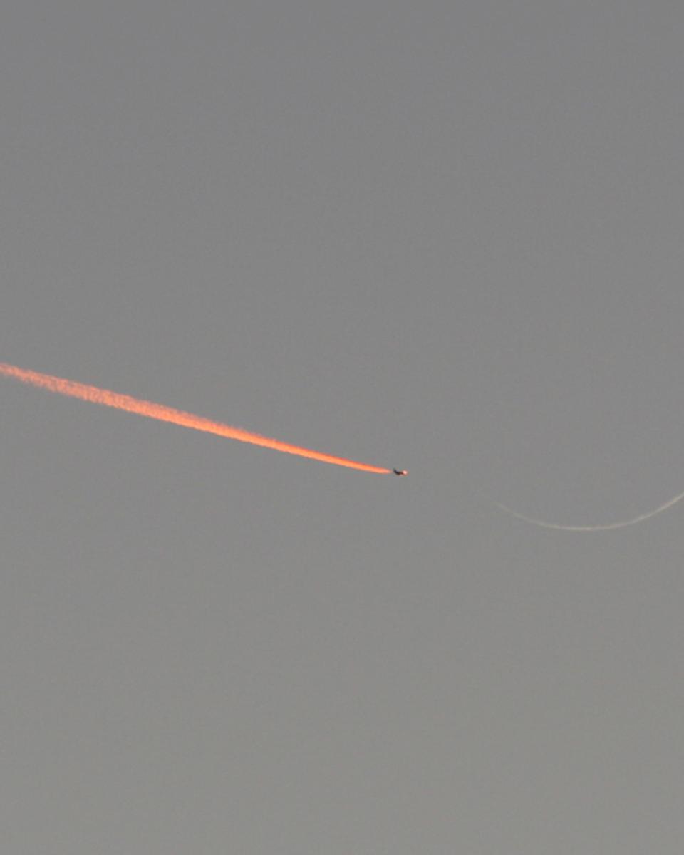 Jet Approaching a Crescent Moon
