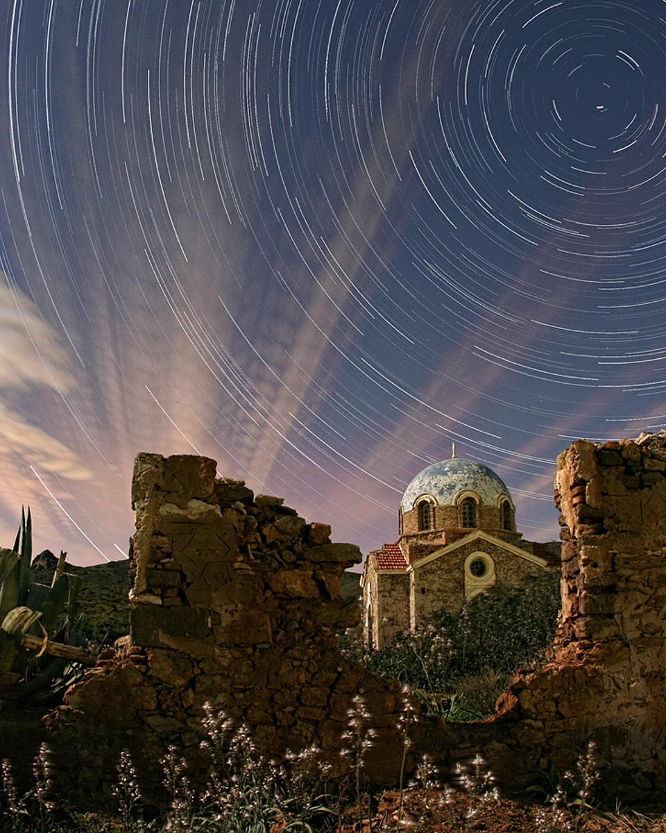 Illuminated Cloud Trails Above Greece