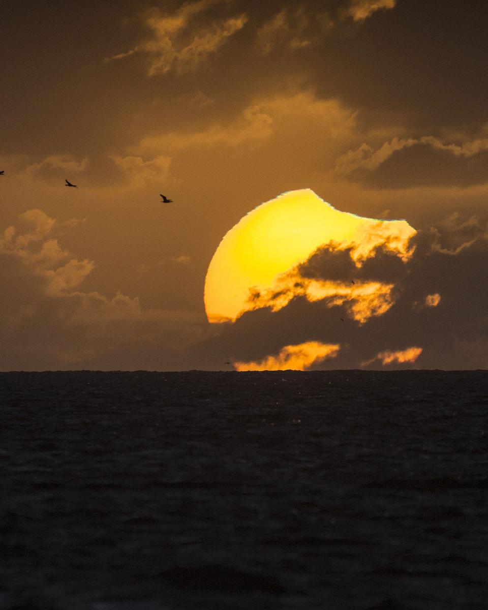 A Partially Eclipsed Setting Sun