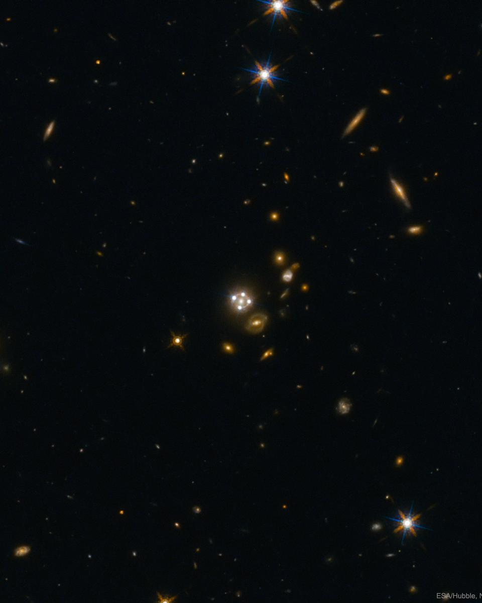 Four Quasar Images Surround a Galaxy Lens