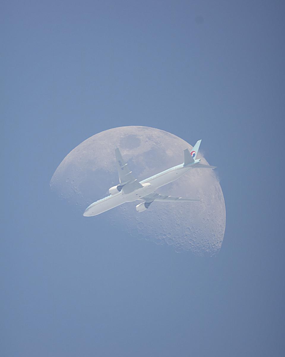 An Airplane in Front of the Moon