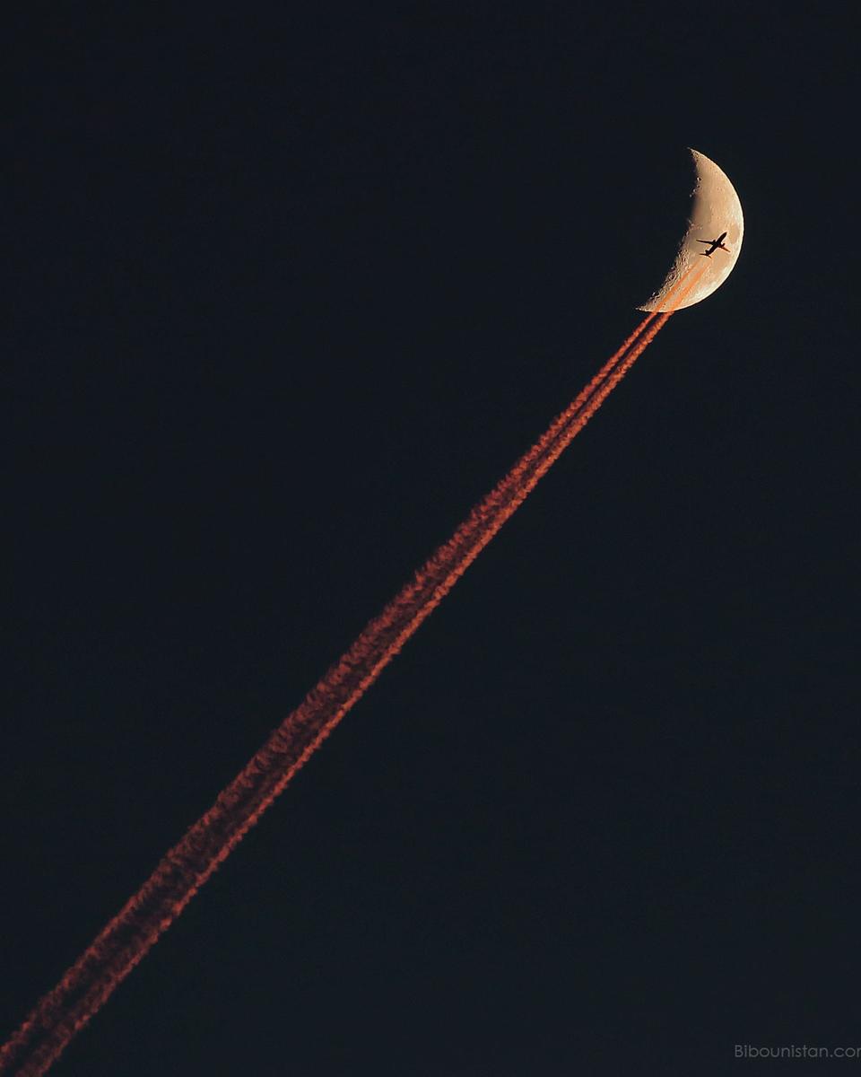 Plane Crossing a Crescent Moon