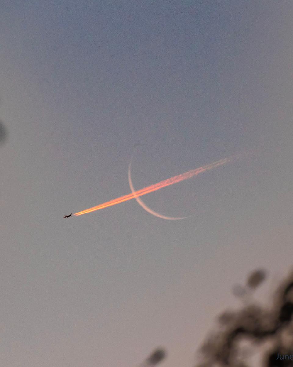 Plane Crossing Crescent Moon