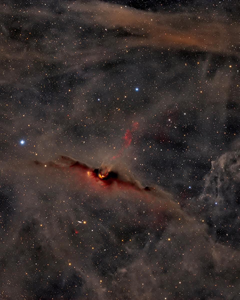 The Red Glow of the Cosmic Bat Nebula
