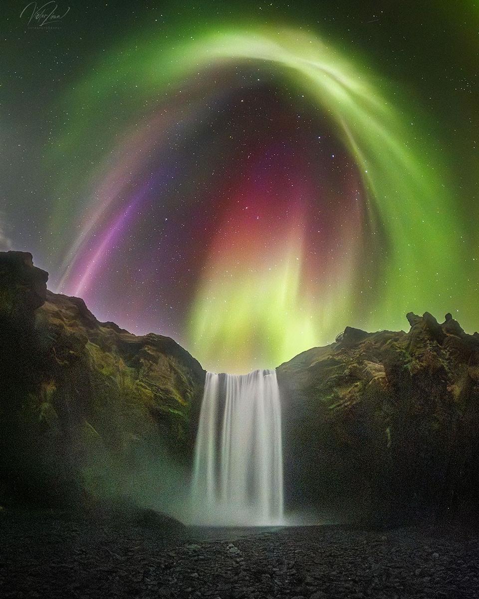 Colorful Aurora over Icelandic Waterfall